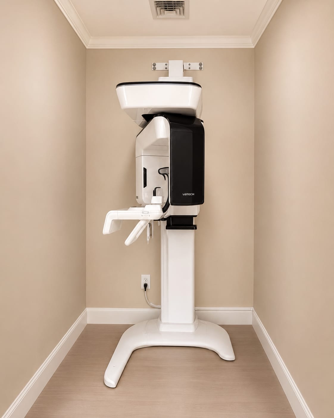 The Vatech panoramic and cone beam computed tomography imaging unit standing against a cream wall in the imaging alcove.