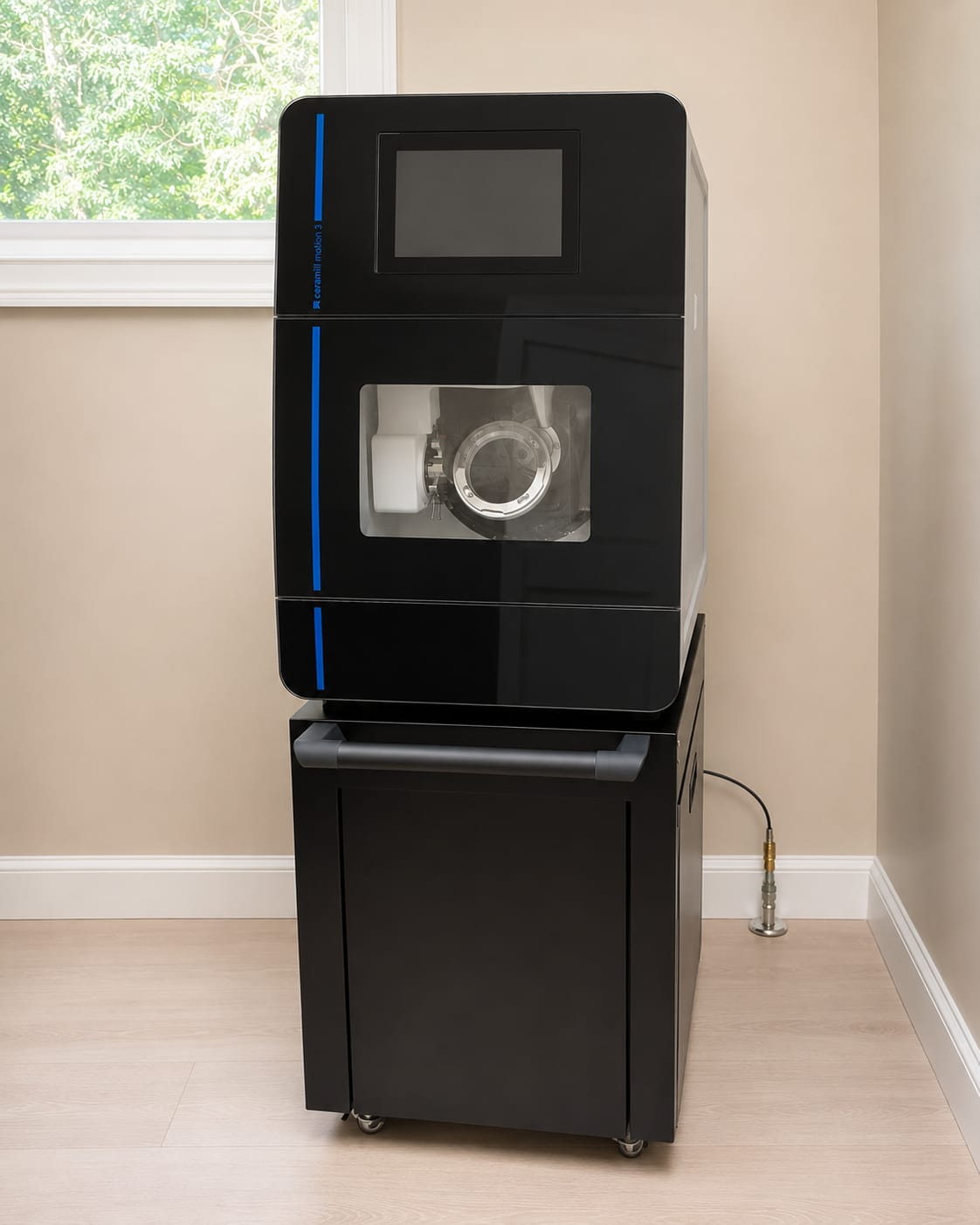 The Amann Girrbach Ceramill Motion 3 five-axis milling unit in the practice lab room, door open to show the milling chamber.